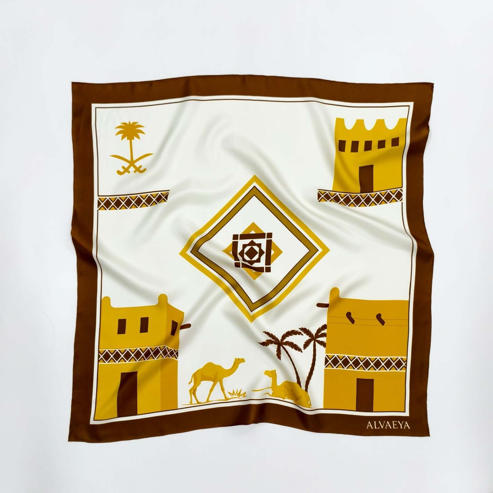 Najd Heritage Silk Scarf design featuring traditional architecture, camels, and palm trees in warm tones, from Alvaeya.