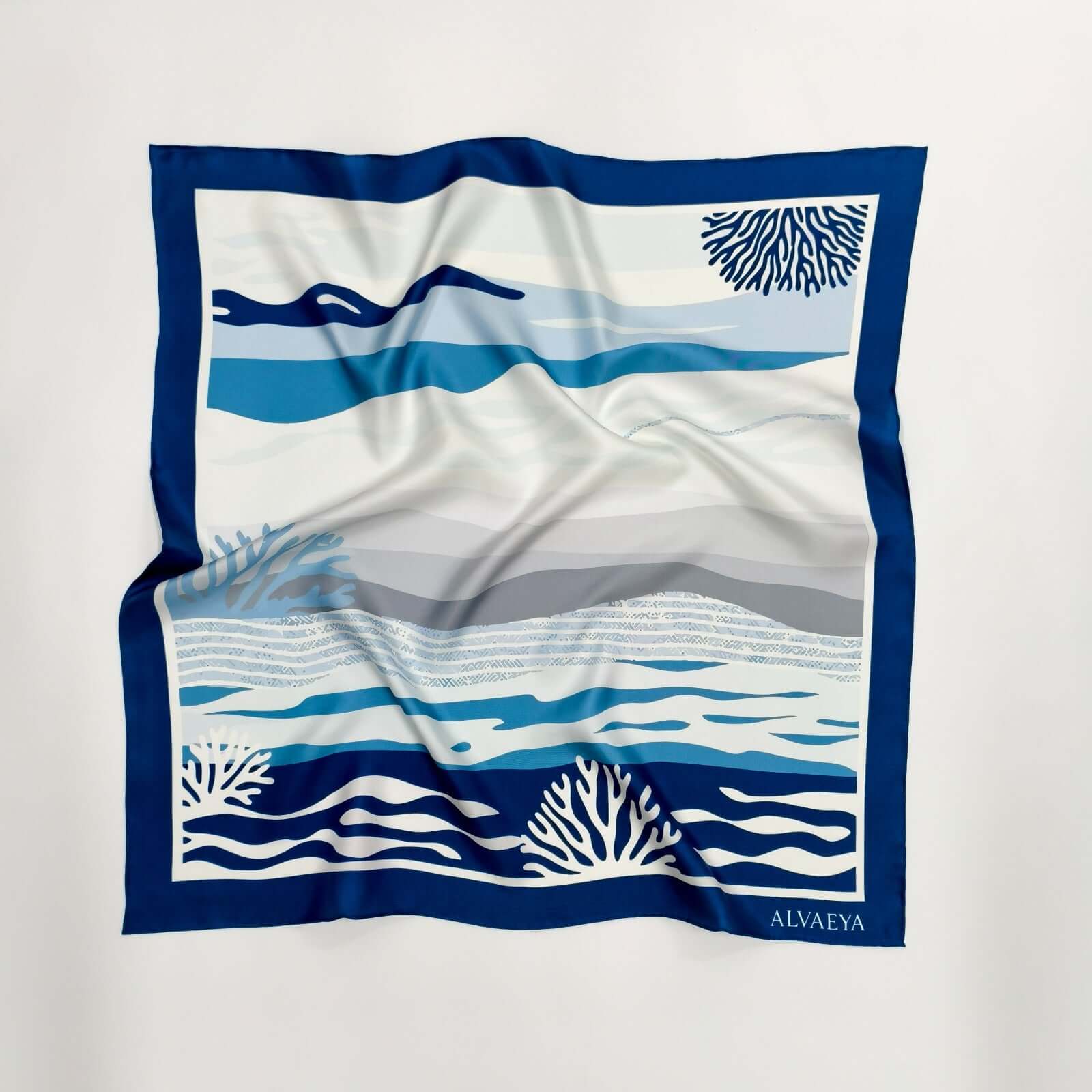 Red Sea Reef Silk Scarf design featuring blue coral patterns and ocean waves from the Lineage Collection.