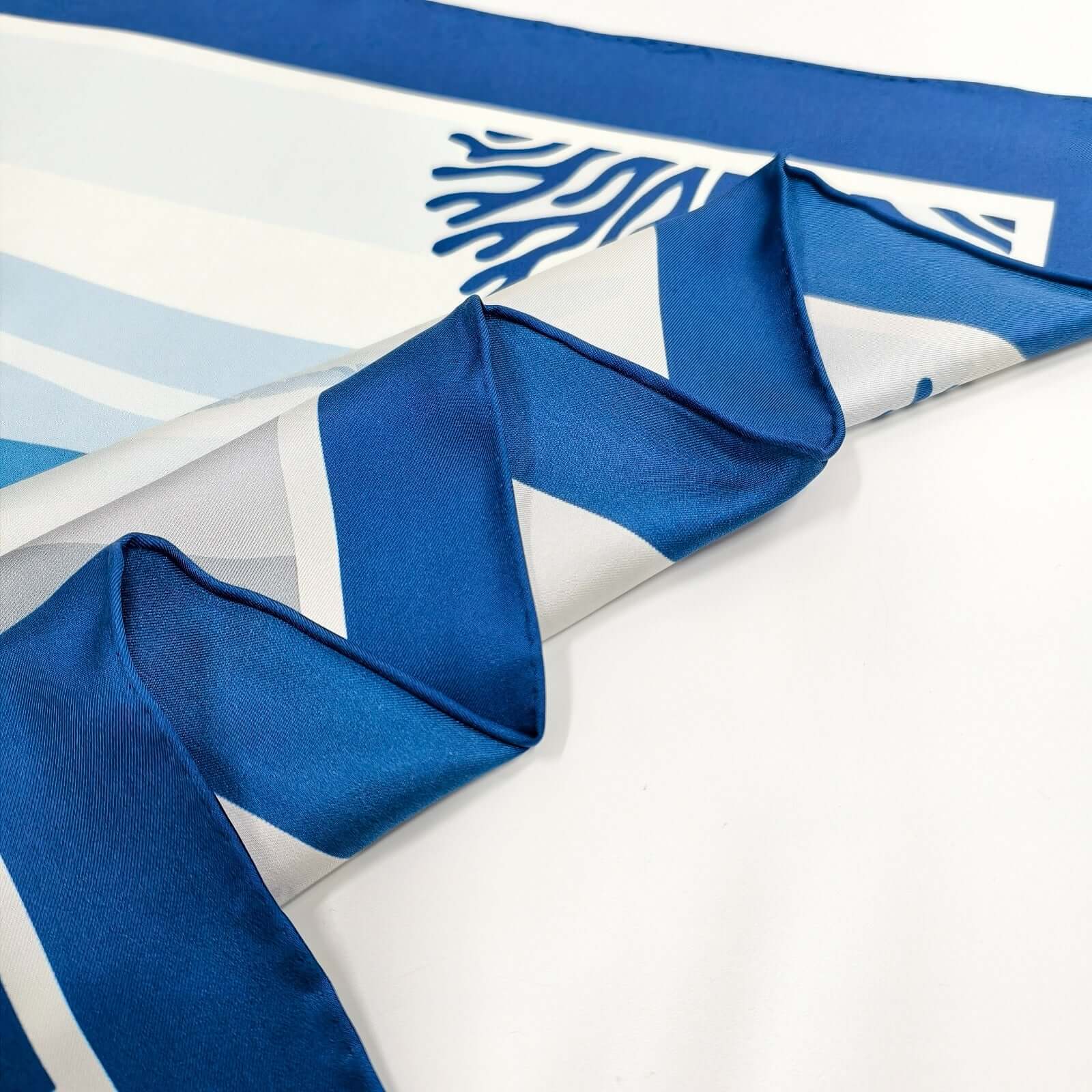 Red Sea Reef Silk Scarf design featuring hand rolled edges and italian craftsmanship.